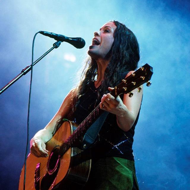 FRANCE - DECEMBER 10: Photo of Alanis MORISSETTE; Alanis Morissette performing on stage at an Amnesty International concert (Photo by Diana Scrimgeour/Redferns)